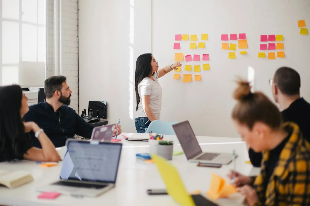 Digital marketing team planning strategy on a whiteboard